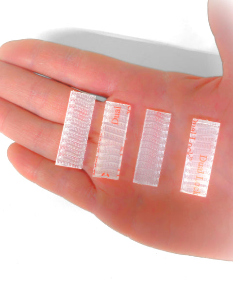 Hand holding four clear strips of Two Sets Of No Brainer Easy Peel And Stick Mounting Strips For EZ Pass IPass IZoom SunPass Transponders Quick On
