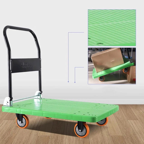 Foldable Flatbed Cart With A Rock Solid Textured Metal Platform And Grippy Four Wheels for moving boxes on a smooth surface.