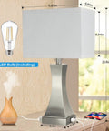 3 Way Dimmable Table Lamp With Touch Control For Bedside Or Desk, Built In USB A And USB C Ports Plus Outlet, 21.6 Inch Tall Nightstand Lamp For Bedroom Living Room Office Or Hotel, Bulb Included with brushed nickel base and linen shade on a table with LED bulb, USB ports, and phone charging.