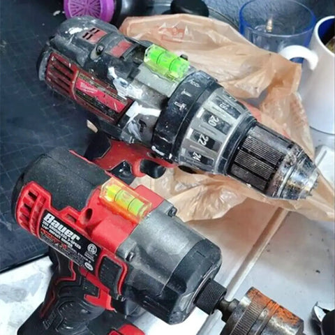 Close-up of drills with built-in bubble levels, part of the Six Pack Mini Magnetic Bubble Level Kit Sleek Acrylic Build With Neon Vials Always Dead On For Quick Measurements Folds Inside Tool Bags Making Tiling And Diy Installations Absolute Breeze For Everyone.