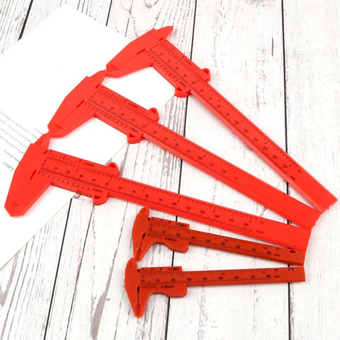 Depth Vernier Caliper Micrometer Gauge Measuring Tool, Multifunctional Depth Caliper in red plastic on wooden surface.