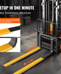 BestEquip forklift extensions installed on yellow pallet forks; 96-inch long, 5.5-inch wide, heavy-duty steel pair