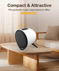 Compact white speaker on table in cozy living room with couch and natural light.