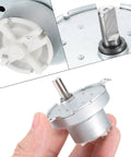 Slow Speed 5V DC D Shaft Gear Motor JS50T With CW CCW 2 RPM Large Torque held in hand and showing D-shaft.