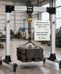 Portable Adjustable Aluminum Gantry Crane with 2 Ton Chain Hoist lifting a heavy block in a workshop environment.