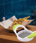 Front view of white and lime green potato cutter with stainless steel grid blades for square-cut fries.