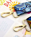 Heavy Duty Gold Zinc Alloy Swivel Lobster Clasps With Push Gate Snaphooks attached to colorful straps on a flat surface.