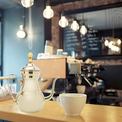 Stainless Steel Arabic Coffee Pot And Pour Over Teapot Set With Infuser in cafe with cup, displaying elegant design on counter