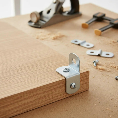 Compact Right Angle Corner Bracket For Woodworking Metal Frame Brace Plate attached to wooden edge with workshop tools