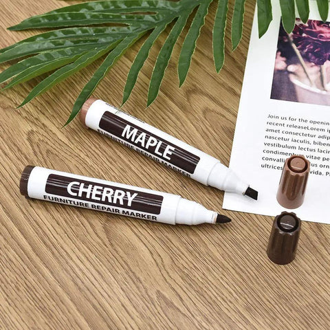Maple and Cherry furniture repair markers on wooden surface. Focus keyword: Furniture Wood Repair Marker For Floors And Tables Easy DIY Scratch Fix Pen For Stains Quick Dry Long Lasting Professional Grade Wood Touch Up For Cabinets And Tables Black Finish