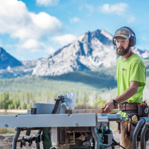 Cordless 36V Table Saw With Brushless Motor, 10 Inch Blade, used by a man outdoors with mountains in the background