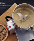 Ultra Fast Electric Grain Grinder 800G Stainless Steel Mill grinding herbs into fine powder, top view of open grinder with lid off.