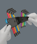 Hands holding Torx L Key Set 9 Piece With Holding Function For Recessed Torx Screws Black Laser Coated, Multicolor Plus with case.