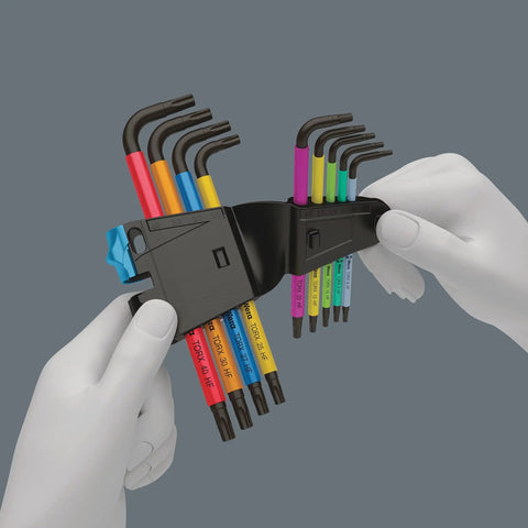 Hands holding Torx L Key Set 9 Piece With Holding Function For Recessed Torx Screws Black Laser Coated, Multicolor Plus with case.