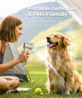 Woman using On The Go Turbo Handheld Fan for Outdoor Adventures with 5000mAh battery to cool a dog at a campsite.