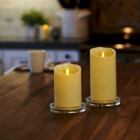 Two Flameless LED Ivory Pillar Candles With Real Wax Look on a Table, Battery Powered, Realistic Moving Flame, Indoor Lighting