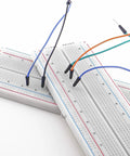Maker Friendly Solderless Breadboard Kit For Arduino Projects With 70 Piece Set, showing two breadboards with colored jumper wires inserted