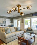 Modern Four Light Gold Glass Globe Ceiling Light Fixture in living room with semi flush mount and rustic vibe.