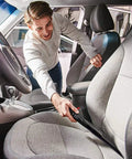 Man cleaning car interior with Heavy Duty Wet Dry Vacuum With 4 HP Motor, 4.5 Gallon Stainless Steel Tank, Wall Mountable, 26 Foot Reach