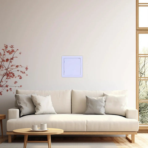 Heavy Grade 6X6 Inch Drywall Access Panel With Concealed Hinge System on a wall above a couch, ideal for easy home repairs.