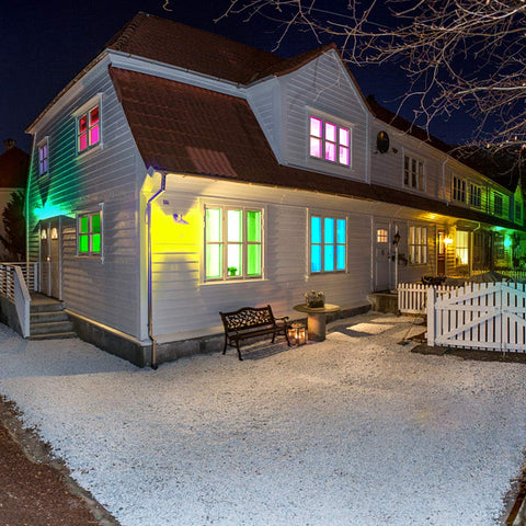 Colorful house exterior lit by RGB LED flood lights for indoor and outdoor decor with remote control waterproof color changing wall washer dimmable security lighting US 3 prong plug 200W 16 color modes and patterns