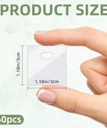 Hand holding a transparent PVC tab from 60 Piece Vertical Blind Repair Tabs Kit With Transparent PVC Adhesive Fixers For Replacement Slats Invisible Snap In Patches Easy DIY Fix No Tools Needed, showing size 1.18in x 1.18in.