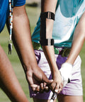 Golfer wearing Must Have Golf Swing Trainer Arm Band for correct swing technique, lightweight and portable practice tool in action