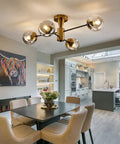 Modern Four Light Gold Glass Globe Ceiling Light Fixture Mid Century Semi Flush Mount in dining room with rustic vibe