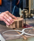 Two 11-inch stainless steel double-ended bowl calipers for woodturning on a workbench.