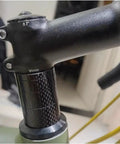 Carbon Fiber Headset Spacers Set For One And One-Eighth Inch Stems, 12 Pcs With 2mm 3mm 5mm 10mm Spacers visible on bike stem