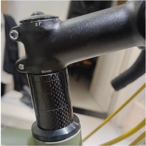 Carbon Fiber Headset Spacers Set For One And One-Eighth Inch Stems, 12 Pcs With 2mm 3mm 5mm 10mm Spacers visible on bike stem