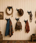 Rustic decor featuring Built Tough 4 Pack Western Bull Horn Hat Hooks In Matte Black Cast Iron Wall Rack with hats and jackets.