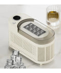 Slick Countertop Ice Maker, Portable Mini Electric Machine making crisp fresh cubes on countertop near whiskey glass.