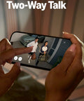 Ring Floodlight Cam Wired Plus live-view on a smartphone screen showing two people at a front door.