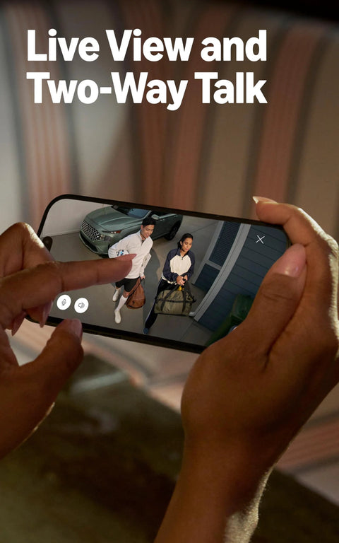 Ring Floodlight Cam Wired Plus live-view on a smartphone screen showing two people at a front door.