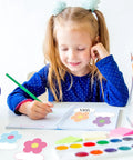 Girl writing with 180 Pcs Flower Name Tag Stickers Set For Back To School, pastel floral design nameplates on desk