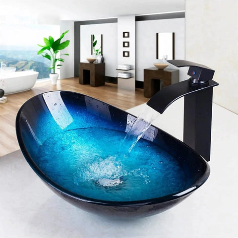 Bathroom Sink Tempered Glass Bathroom Vessel Vanity Sink with black faucet and blue water in a modern bathroom setting.