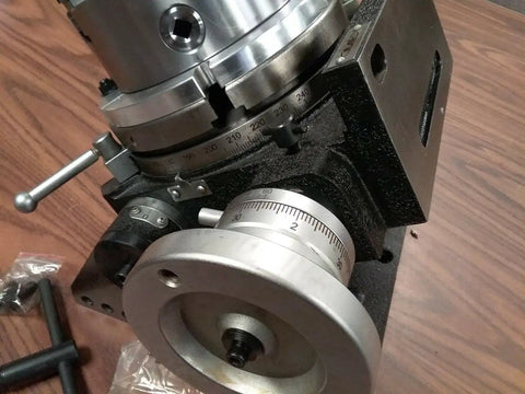 Precision Tilting Rotary Table With Three Jaw Chuck And Six Inch Centering Adapter, showing angle dial and heavy base.