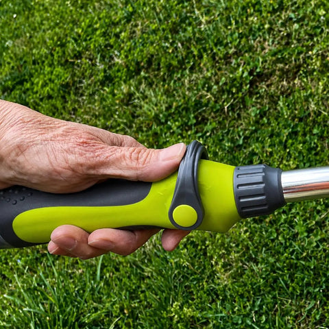 Close-up of hand holding 15 Inch Watering Wand With 8 Spray Patterns And Thumb Control for Reaching Hanging Baskets and Deep Beds.
