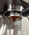 54mm Bottomless Naked Portafilter For Breville Sage Barista Series Espresso Machines Including Barista Express Pro Touch Infuser Duo Temp Pro BES870 BES878 BES880 extracting coffee shot into glass