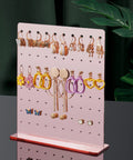 Rose Gold Mirror Finish Acrylic Earring Stand Three Pack Set displaying various earrings on tabletop