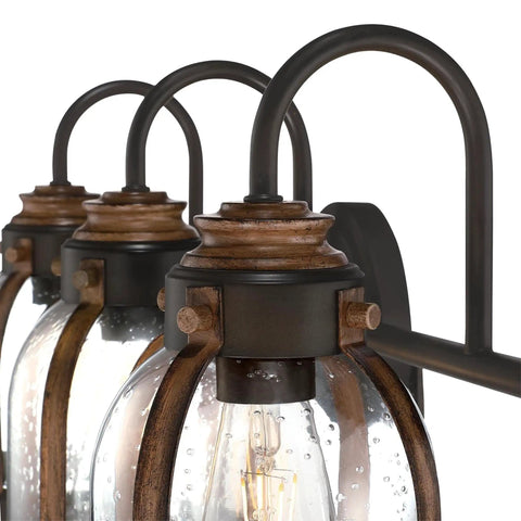 Close-up of Vintage Style Three Light Indoor Vanity Light Fixture In Oil Rubbed Bronze With Barnwood Accents And Hand Blown Clear Seeded Glass