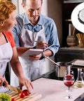 Two people cooking together in a kitchen with 40 Pack Clear Smoke Detector Covers visible for protection against grime.