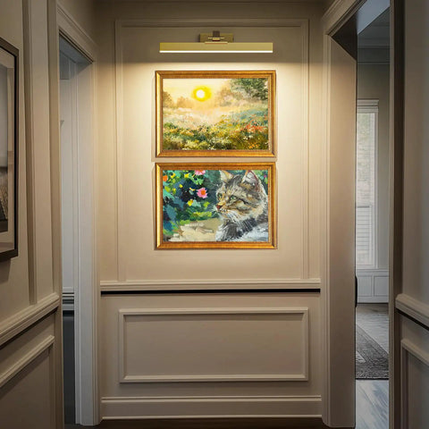 Brushed Gold Battery Operated Picture Light 16 Inch With Dimmable CCT illuminating framed art in a hallway, no glare