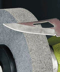 Close-up of a knife blade on a 6 Inch Nylon Fiber Buffing Wheel from the 6 Inch Nylon Fiber Buffing Wheels Pack Of 3 With 180 Grit.