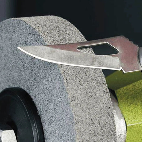 Close-up of a knife blade on a 6 Inch Nylon Fiber Buffing Wheel from the 6 Inch Nylon Fiber Buffing Wheels Pack Of 3 With 180 Grit.