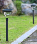 50 Lumen Solar Path Lights 42X Brighter Than Standard Garden Lighting Matte Black 4 pack illuminating a garden path