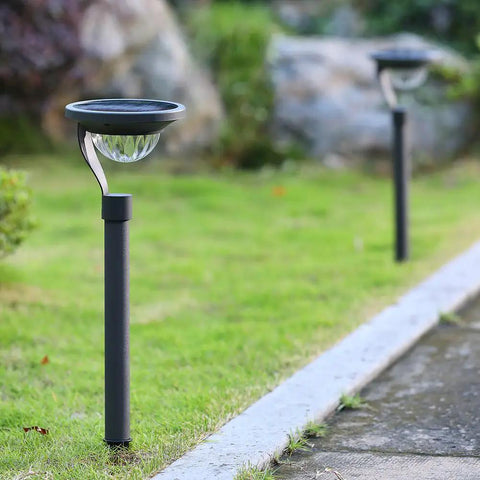 50 Lumen Solar Path Lights 42X Brighter Than Standard Garden Lighting Matte Black 4 pack illuminating a garden path