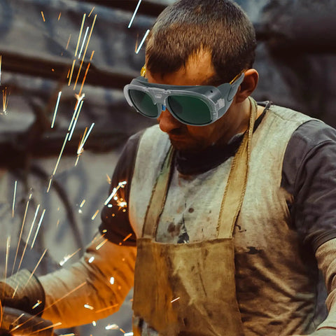Man wearing Badass Impact Resistant Welding Safety Goggles 3 Piece Set In Black Gray Shades while welding.