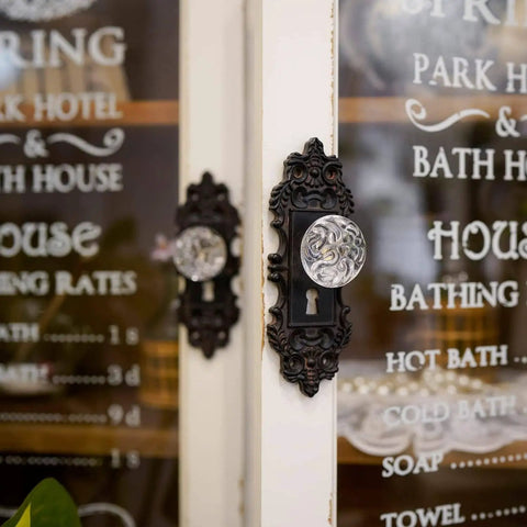 Side view of Two Piece Vintage Cabinet Pull Drawer Knob Set With Clear Resin Knob Distressed Pewter Finish Old School Retro Appeal For Cupboard Kitchen Furniture Mounting Screws Included Black mounted on vintage door.